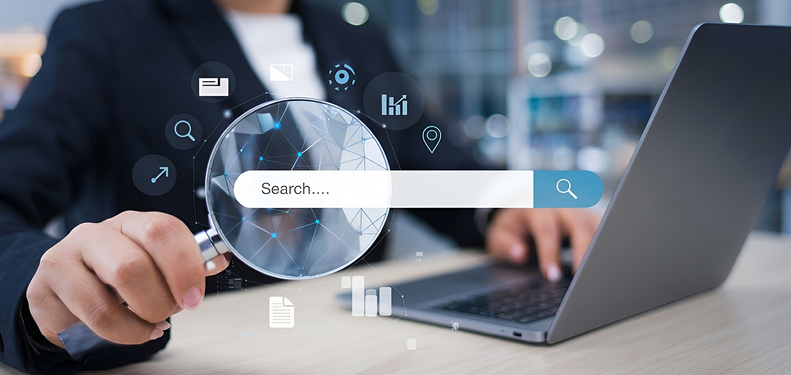 A professional in a dark suit using a laptop while holding a magnifying glass over a digital search bar with floating analytics, location, and data icons, illustrating how AI-native SEO companies in Orange County outgrow traditional agencies