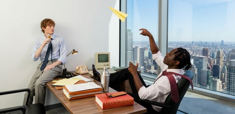 Two executives in a high-rise office with a city skyline view, featuring vintage desktop equipment and a yellow paper airplane, illustrating strategic hybrid AI SEO leadership for businesses in Anaheim, CA