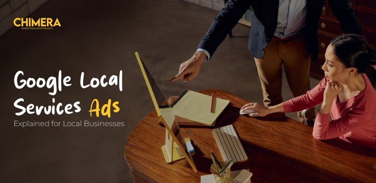 Two experts talking about data on a desktop computer, visually describing why Google Local Services Ads can be used to provide leads to local businesses.